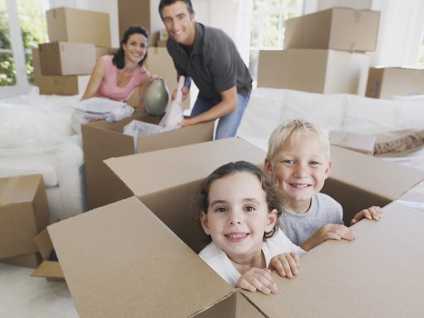 Professional movers carrying furniture down stairs in a Lambeth flat move