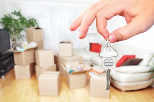 Removal team planning a flat move in Lambeth with boxes and furniture